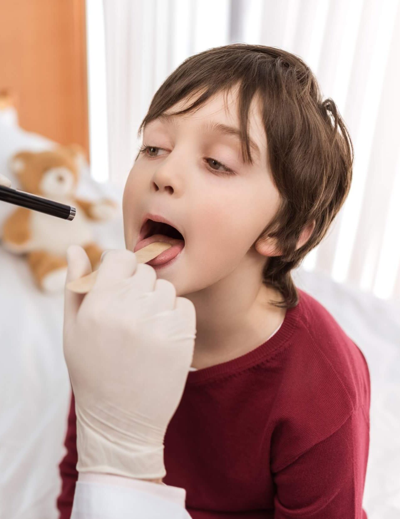 man-doctor-examining-throat-of-little-boy-in-hospi-2021-09-03-16-51-18-utc-e1644252180701.jpg man-doctor-examining-throat-of-little-boy-in-hospi-2021-09-03-16-51-18-utc-e1644252180701.jpg